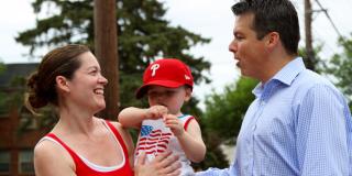 Rep. Boyle talking to a woman with a baby