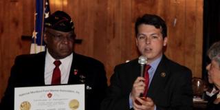 Military soldier saluting American flag