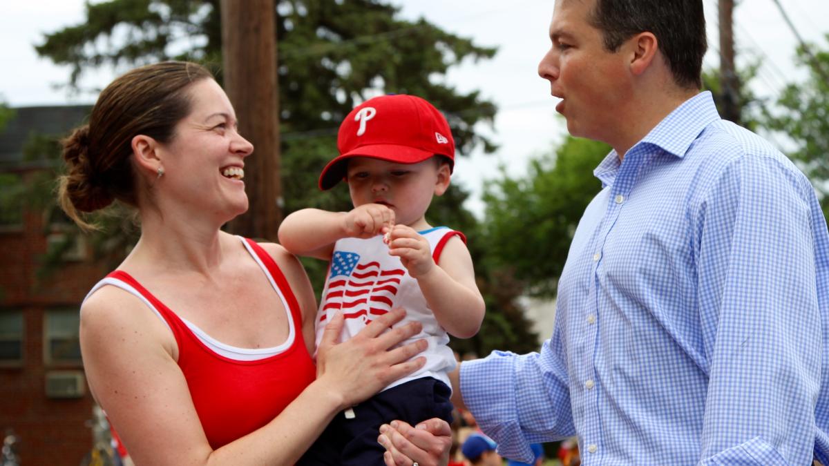 Rep. Boyle talking to a woman with a baby