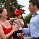 Rep. Boyle talking to a woman with a baby